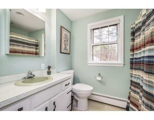 67 Wildwood Road Stow, MA 01775 - Photo 21 of 30 a bathroom with a sink a toilet a mirror and a window