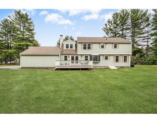 67 Wildwood Road Stow, MA 01775 - Photo 28 of 30 a front view of a house with a garden and sitting area