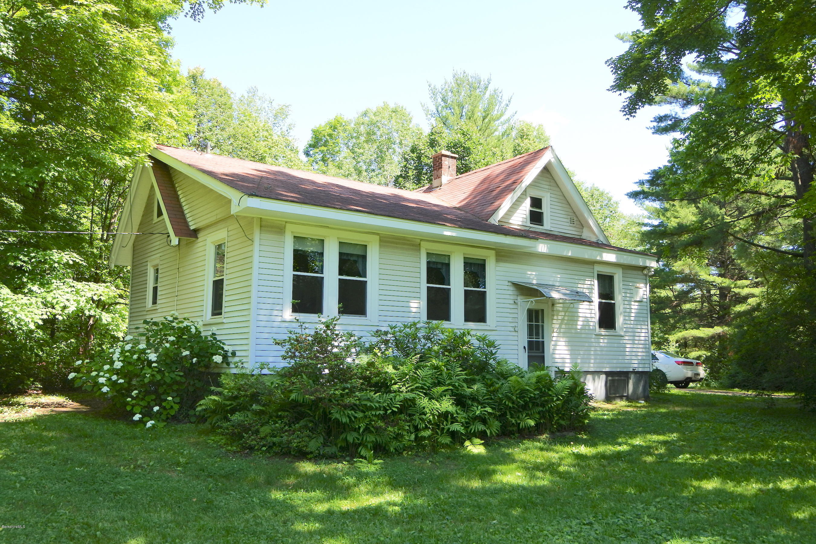 2609 State Road Richmond, MA 01254 - Photo 1 of 22 a front view of a house with a yard and trees