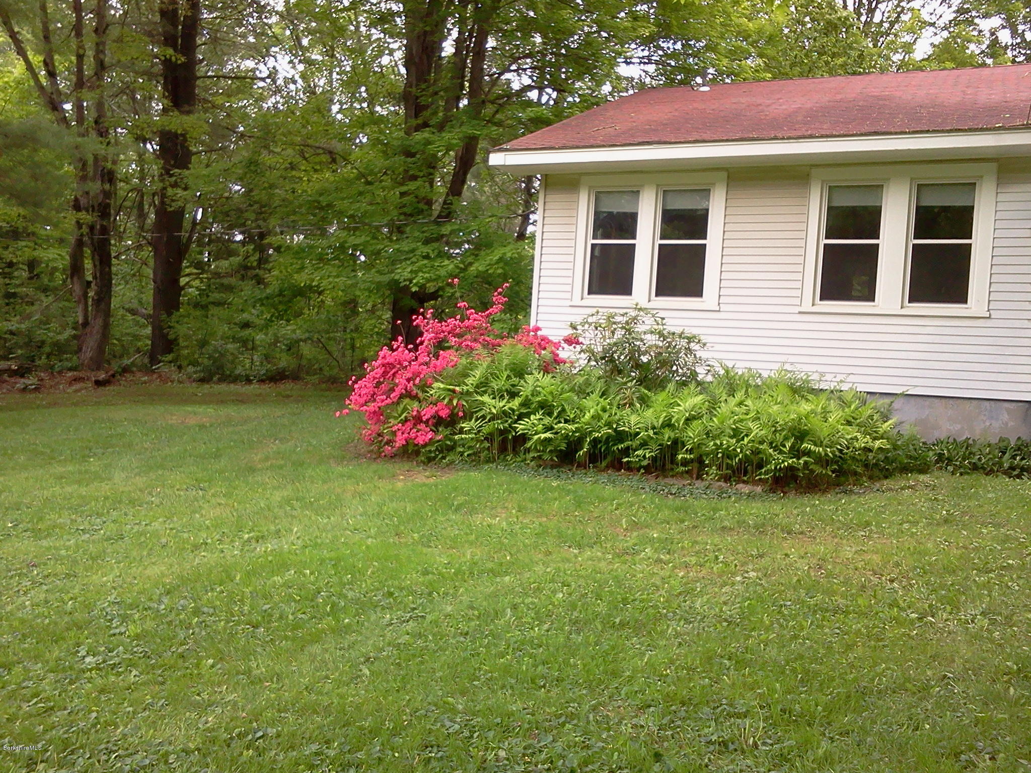 2609 State Road Richmond, MA 01254 - Photo 9 of 22 a front view of a house with a yard and fountain in middle