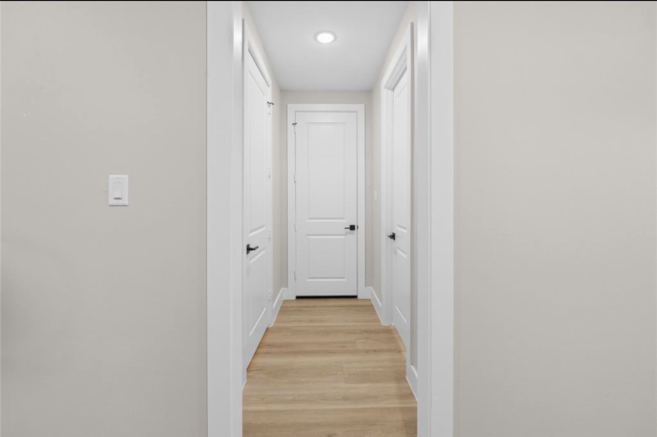 2610 Piemonte Ave Spring Spring, TX 77388 - Photo 4 of 10 a view of a hallway with wooden floor and a bathroom