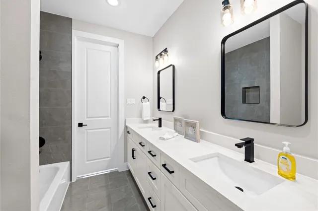 a bathroom with a double vanity sink mirror and