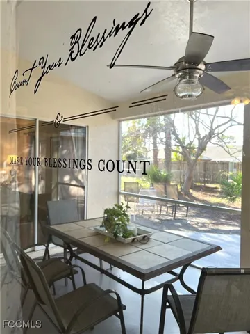 a living room with furniture and a large mirror with wooden floor