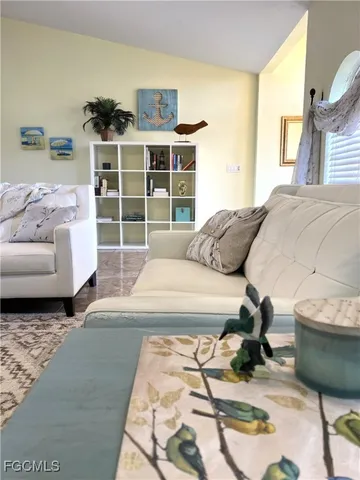 a living room with a couch and a walk in closet