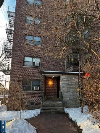 a front view of a building with plants