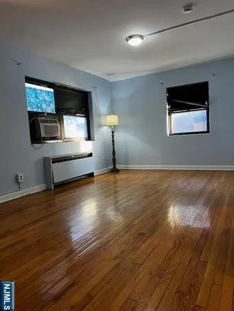 a living room with hard wood floors and a wooden floor