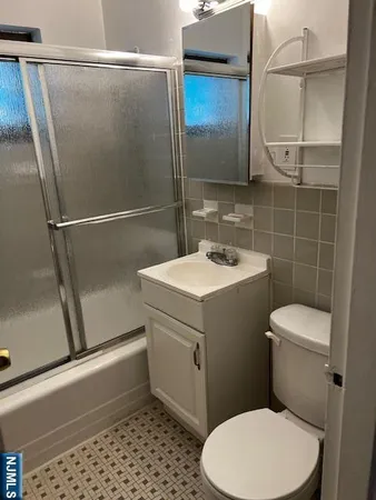 a white toilet sitting next to a bathroom sink