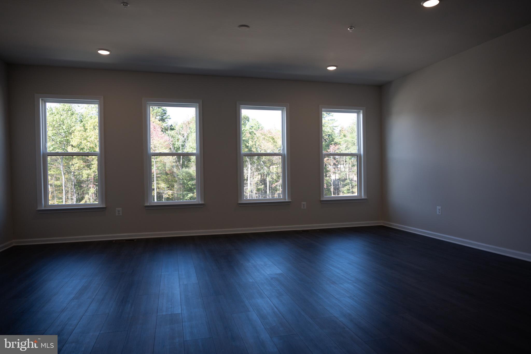 238 Mainstream Drive Laurel, MD 20724 - Photo 21 of 45 an empty room with wooden floor and windows