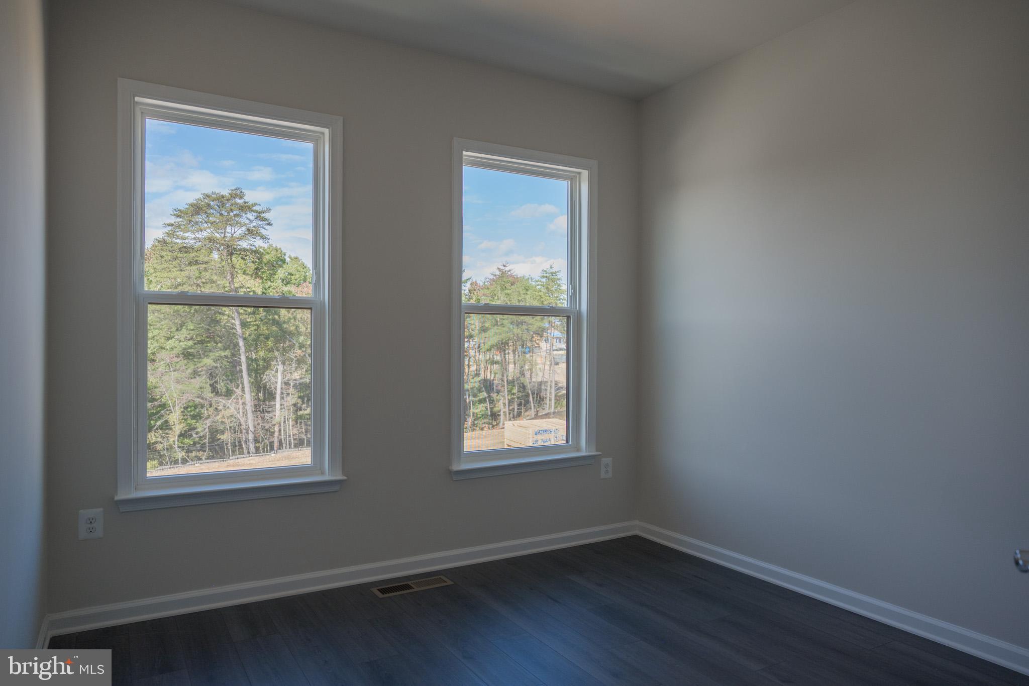 238 Mainstream Drive Laurel, MD 20724 - Photo 30 of 45 a view of an empty room with wooden floor and a window