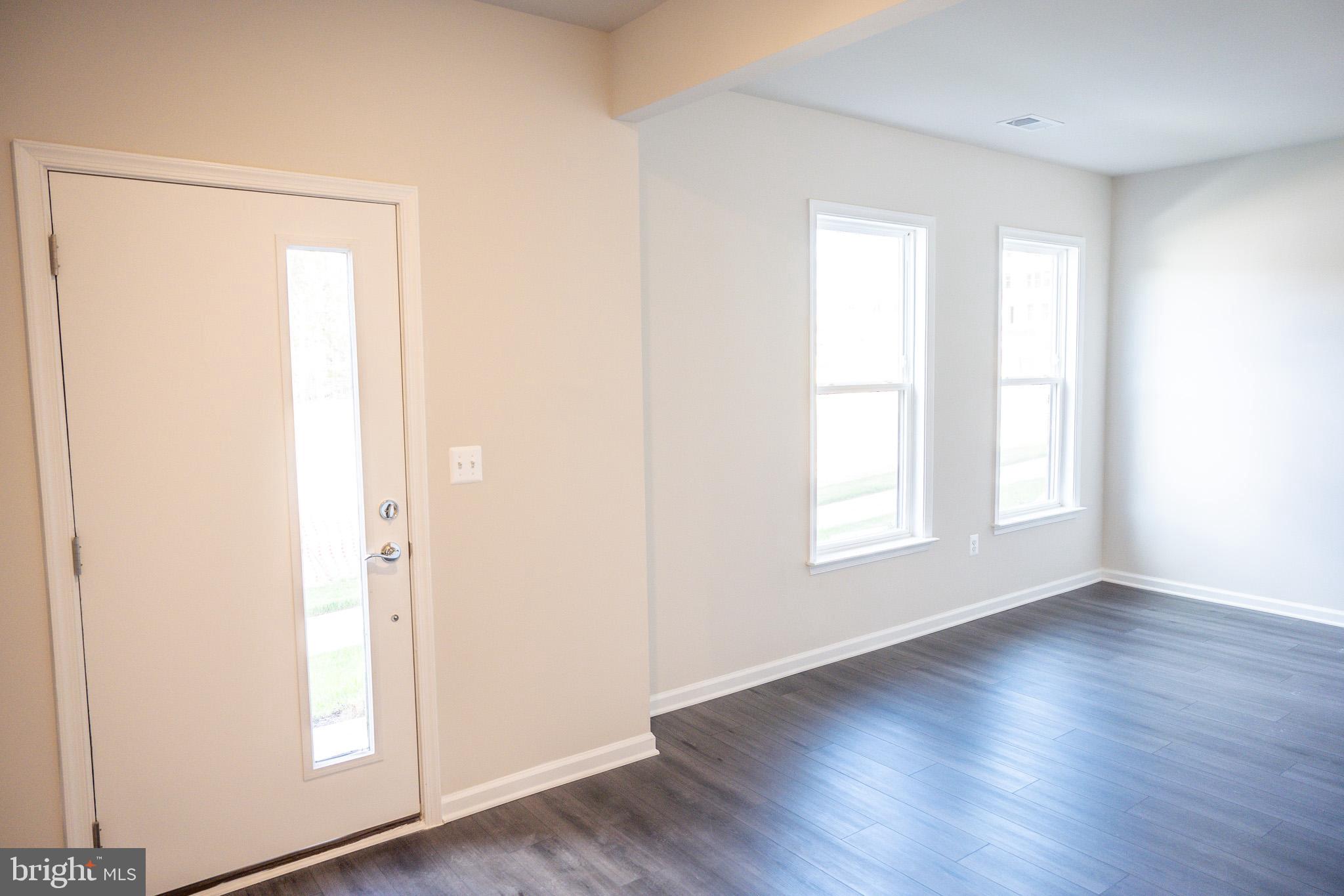 238 Mainstream Drive Laurel, MD 20724 - Photo 33 of 45 a view of an empty room with wooden floor and a window