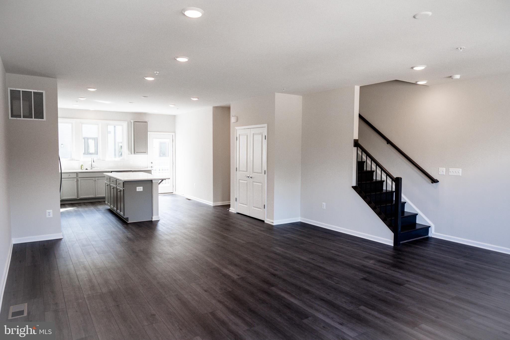 238 Mainstream Drive Laurel, MD 20724 - Photo 36 of 45 a living room with stainless steel appliances wooden floors and kitchen view