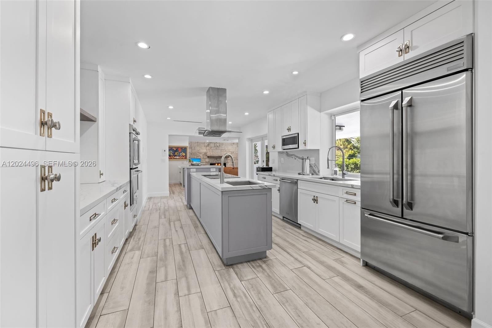 6875 North Cartee Road Palmetto Bay, FL 33158 - Photo 12 of 42 a kitchen with white cabinets and stainless steel appliances