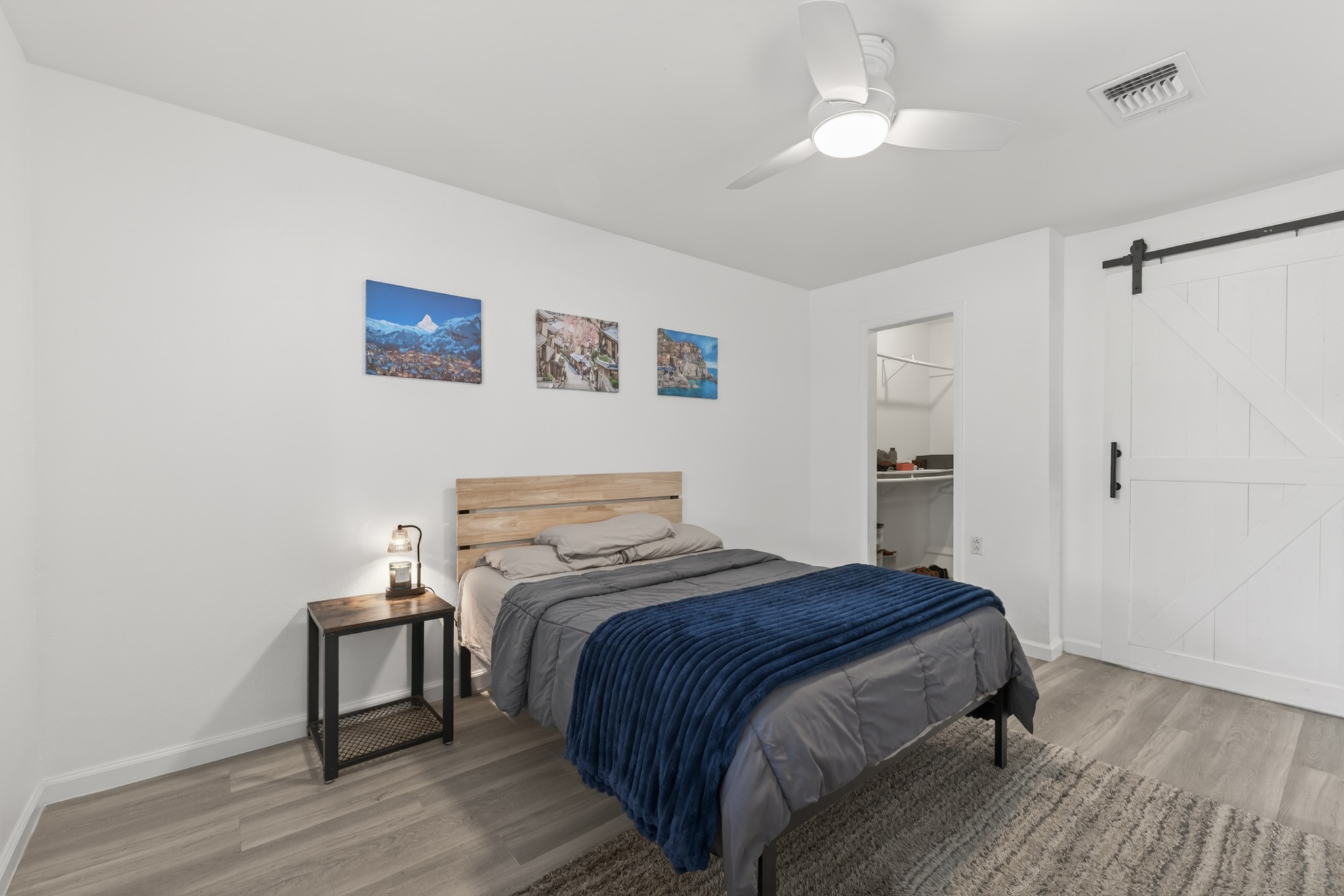 8210 Bent Tree Road, Unit 116 Austin, TX 78759 - Photo 17 of 25 a bedroom with a bed and a chandelier
