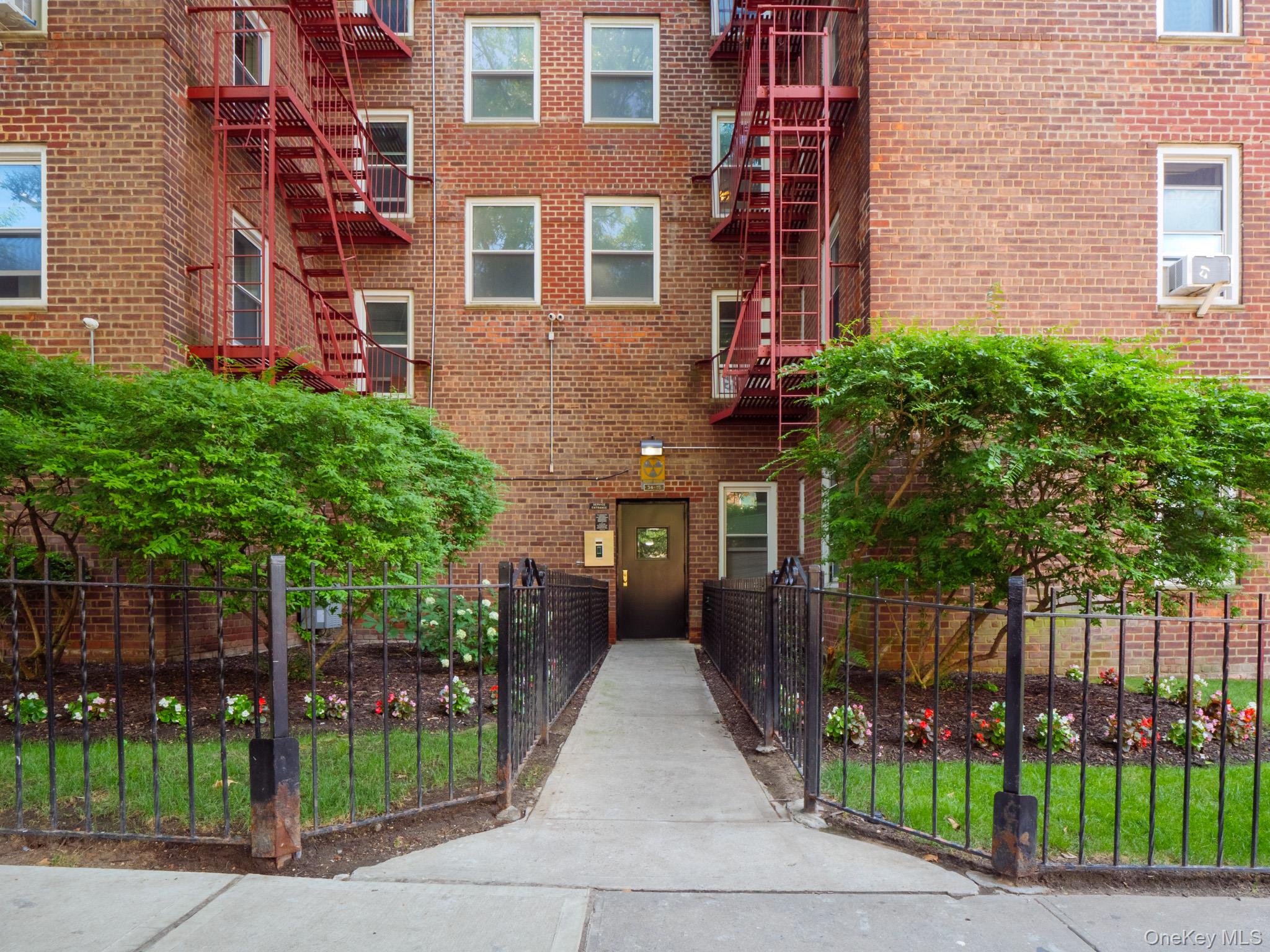 34-15 74th Street, Unit 4H Queens, NY 11372 - Photo 12 of 19 front view of a house with a garden