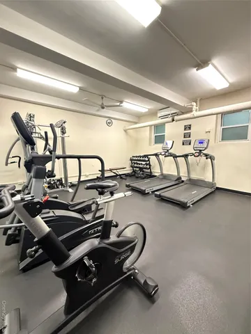 a living room with furniture wooden floor and a chandelier