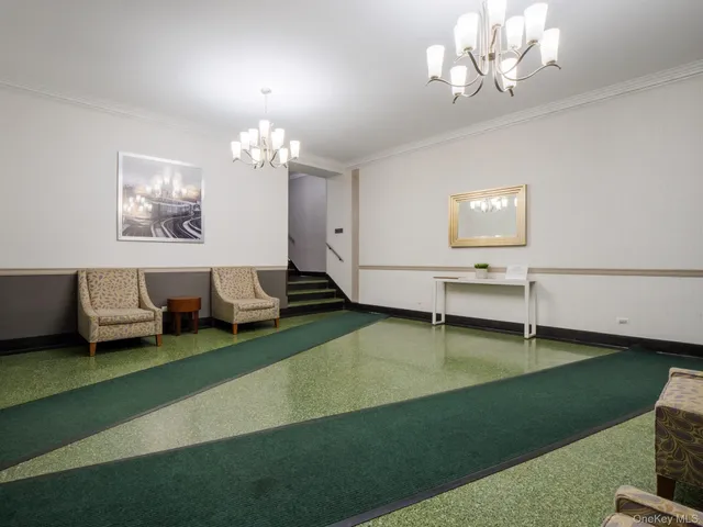 a living room with furniture and a chandelier