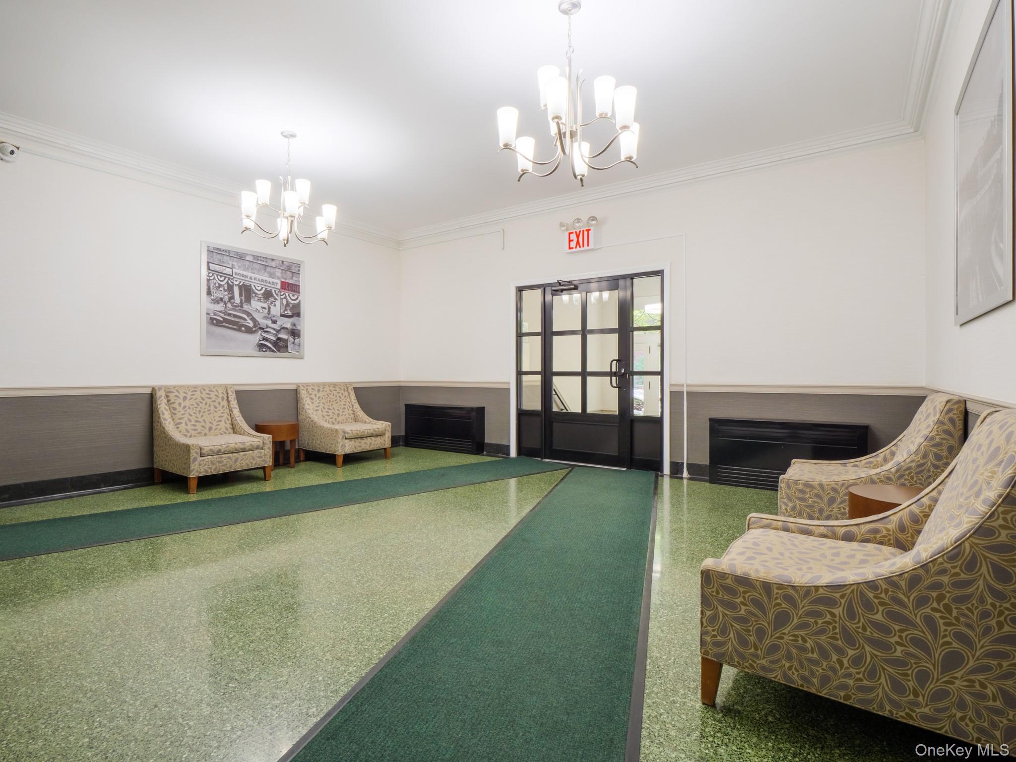 34-15 74th Street, Unit 4H Queens, NY 11372 - Photo 18 of 19 a living room with furniture and a chandelier