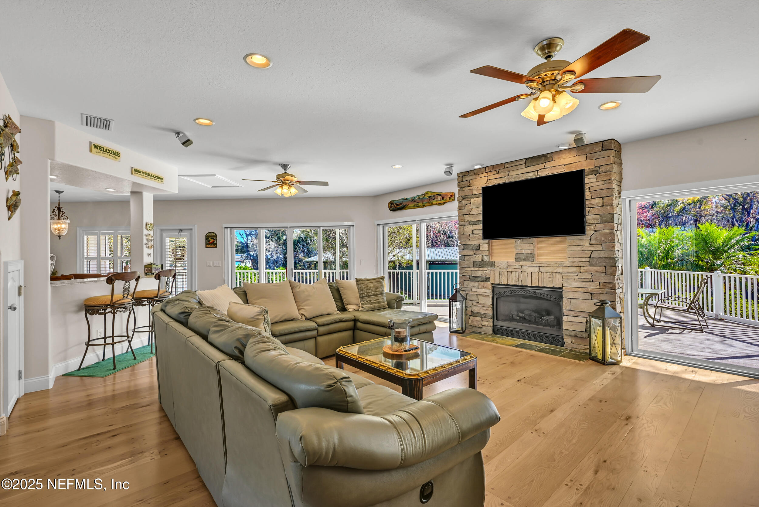 56633 Otter Road Astor, FL 32102 - Photo 11 of 69 a living room with fireplace furniture and a flat screen tv