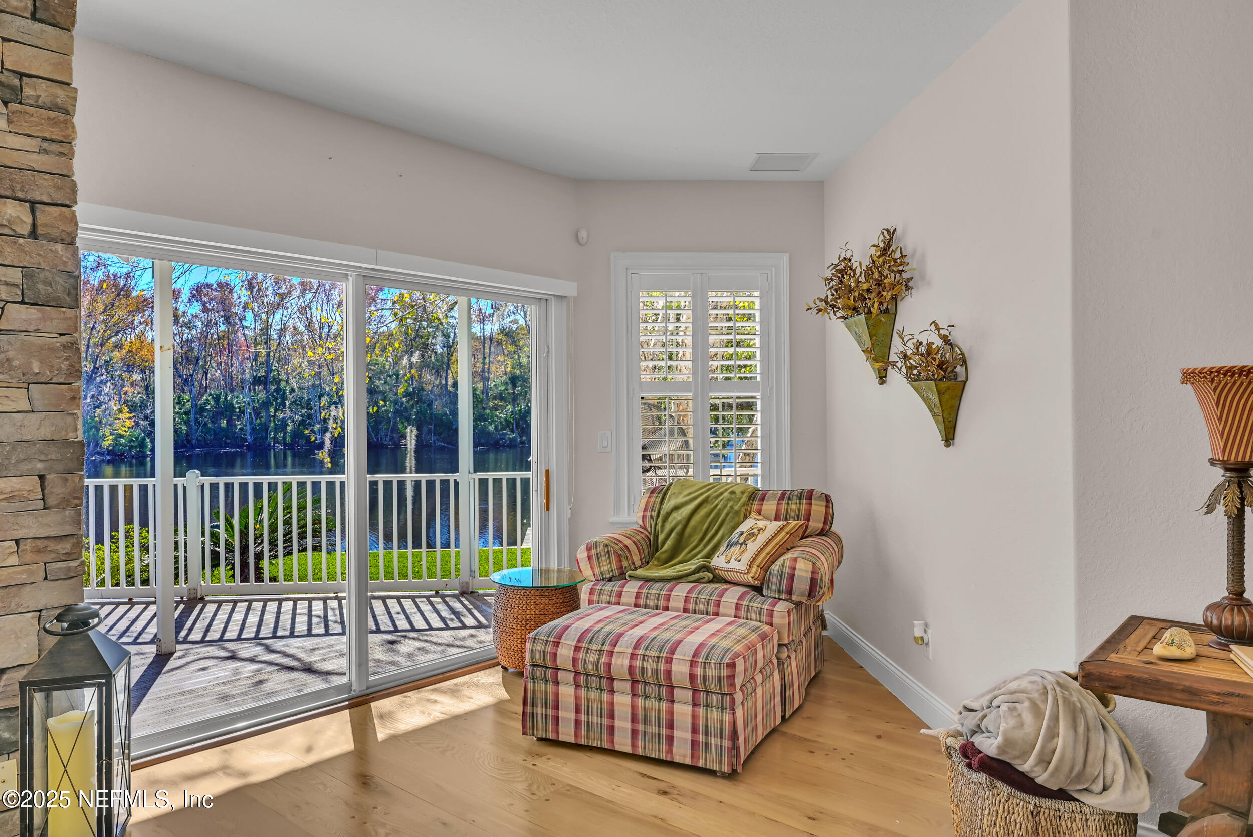 56633 Otter Road Astor, FL 32102 - Photo 17 of 69 a living room with furniture and a floor to ceiling window