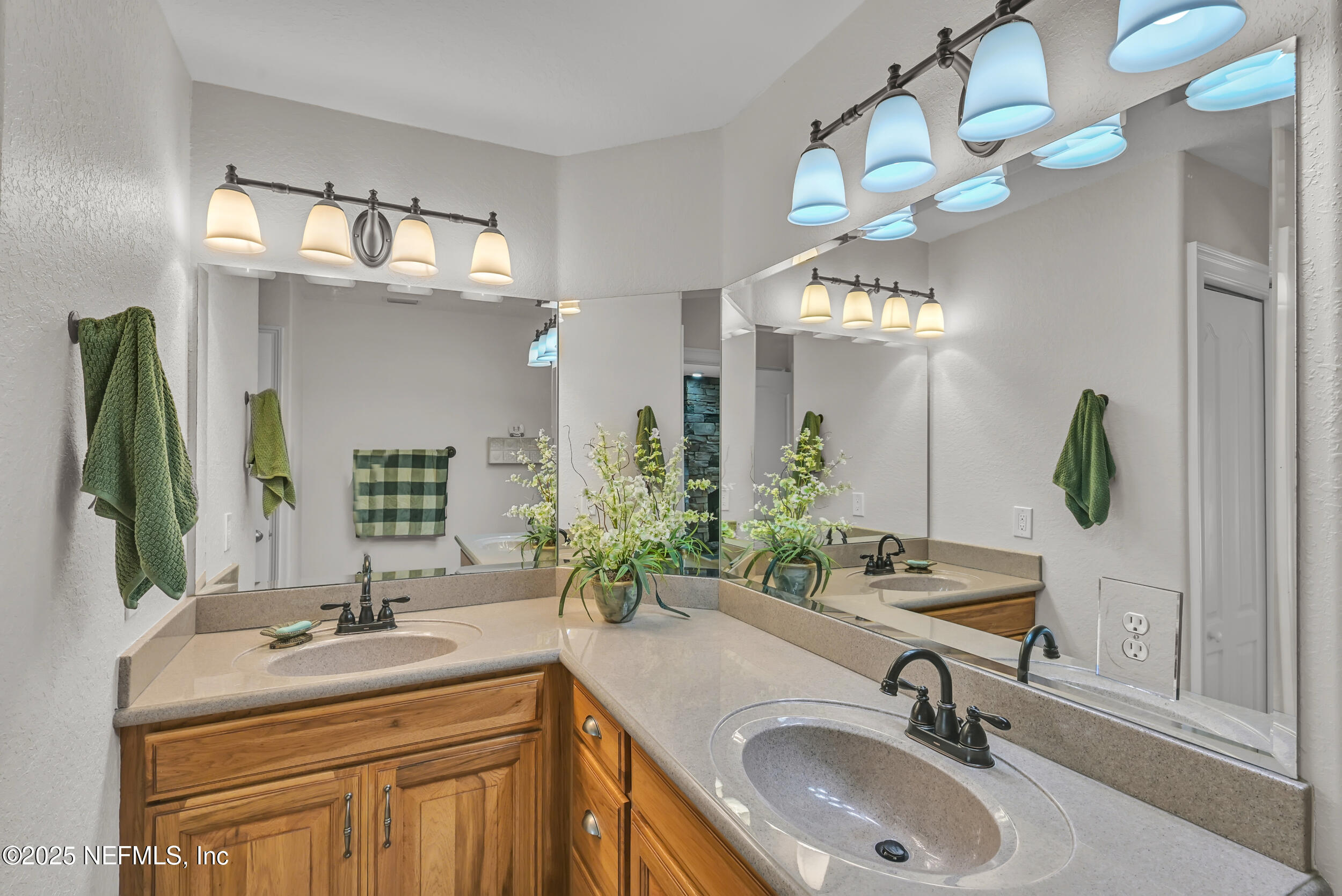 56633 Otter Road Astor, FL 32102 - Photo 23 of 69 a bathroom with double vanity sinks a vanity a lamp and a mirror
