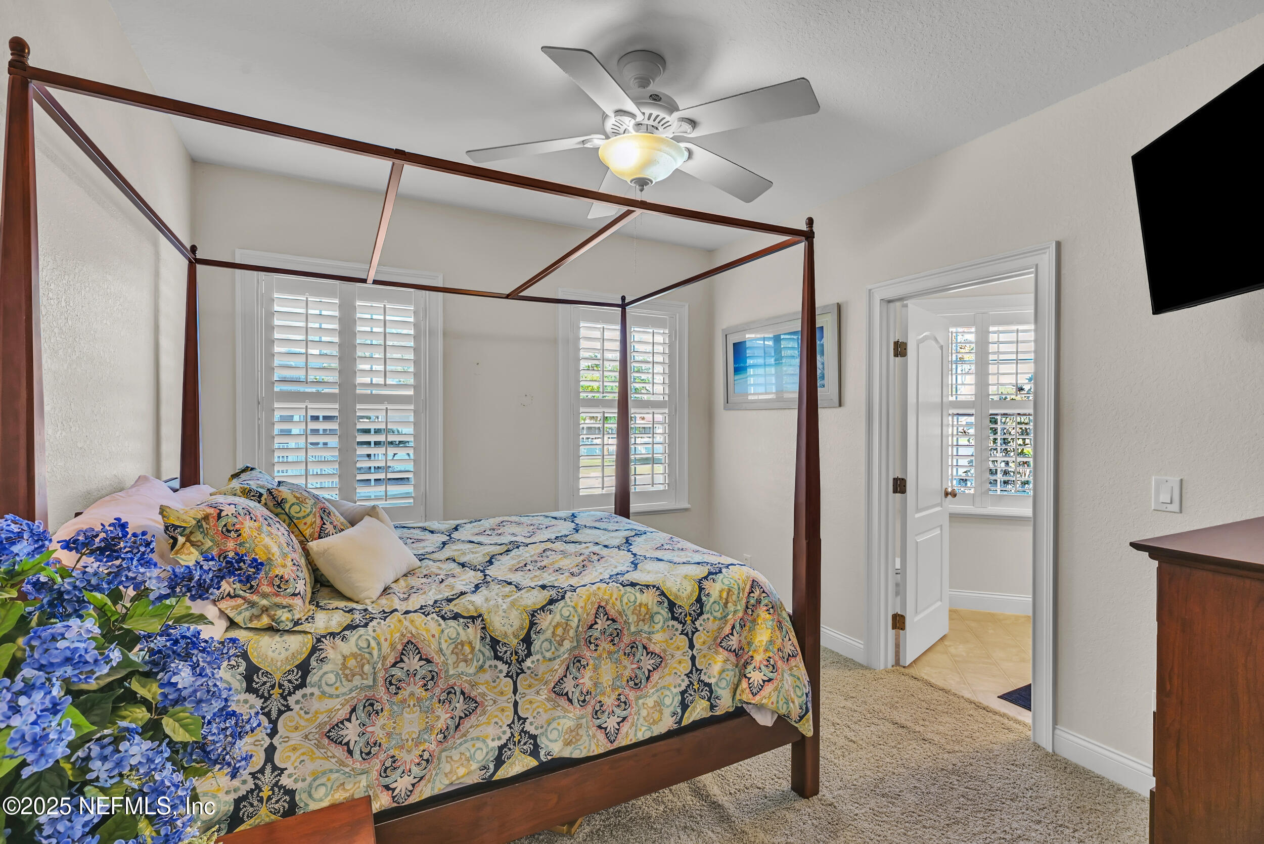 56633 Otter Road Astor, FL 32102 - Photo 27 of 69 a bedroom with a bed and a chandelier