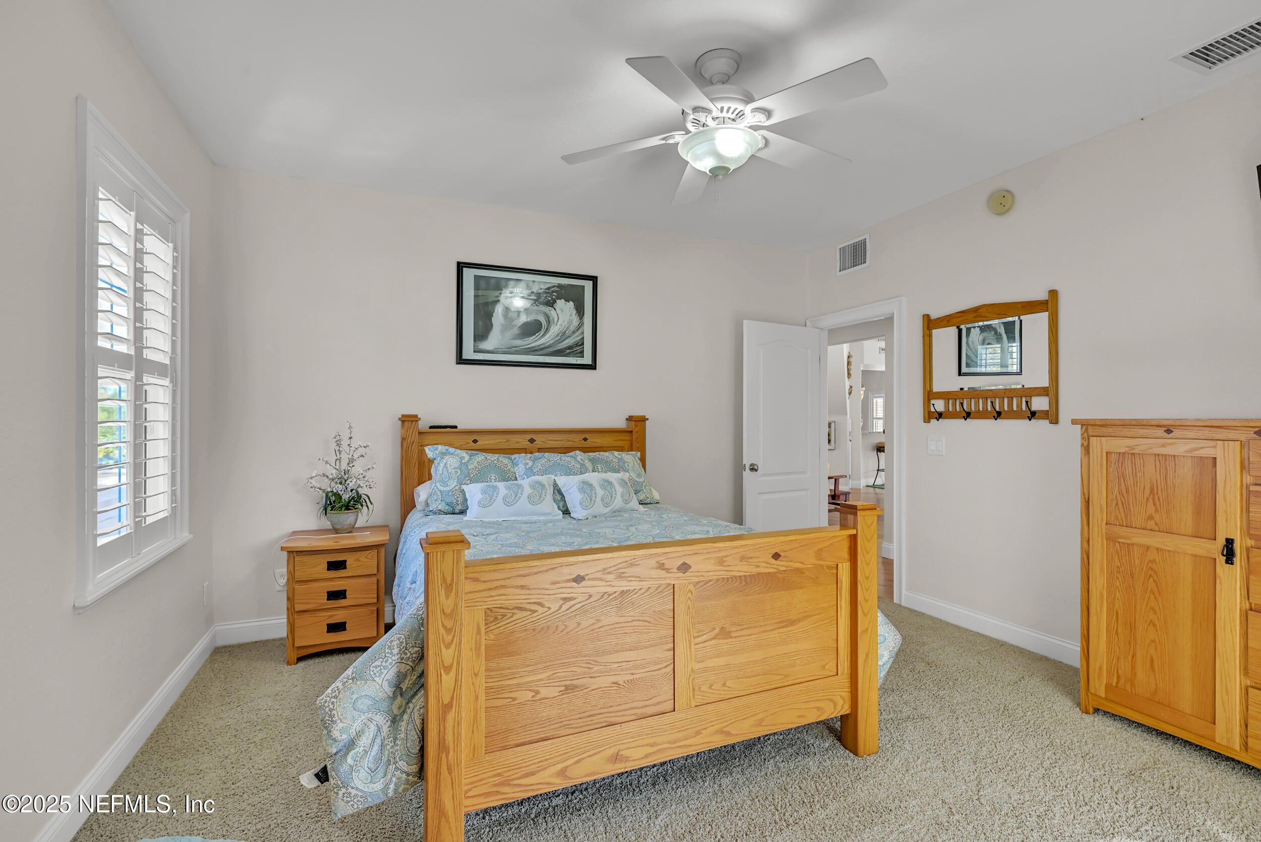 56633 Otter Road Astor, FL 32102 - Photo 32 of 69 a bedroom with a bed and a window