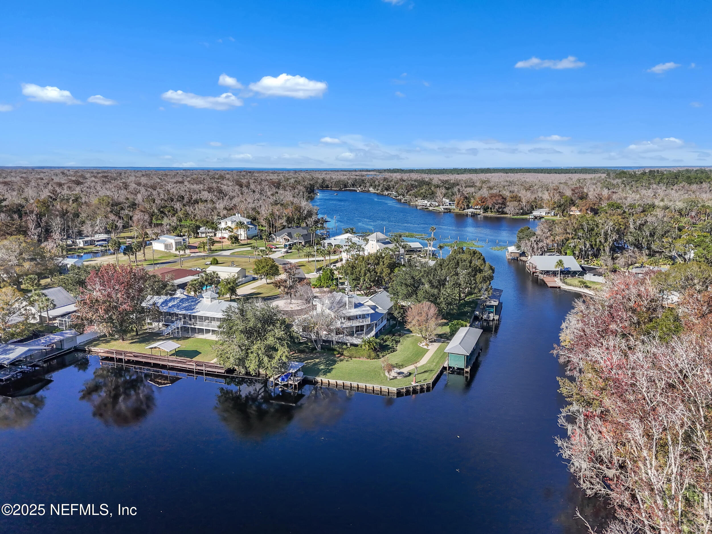 56633 Otter Road Astor, FL 32102 - Photo 41 of 69 a view of a lake with lawn chairs