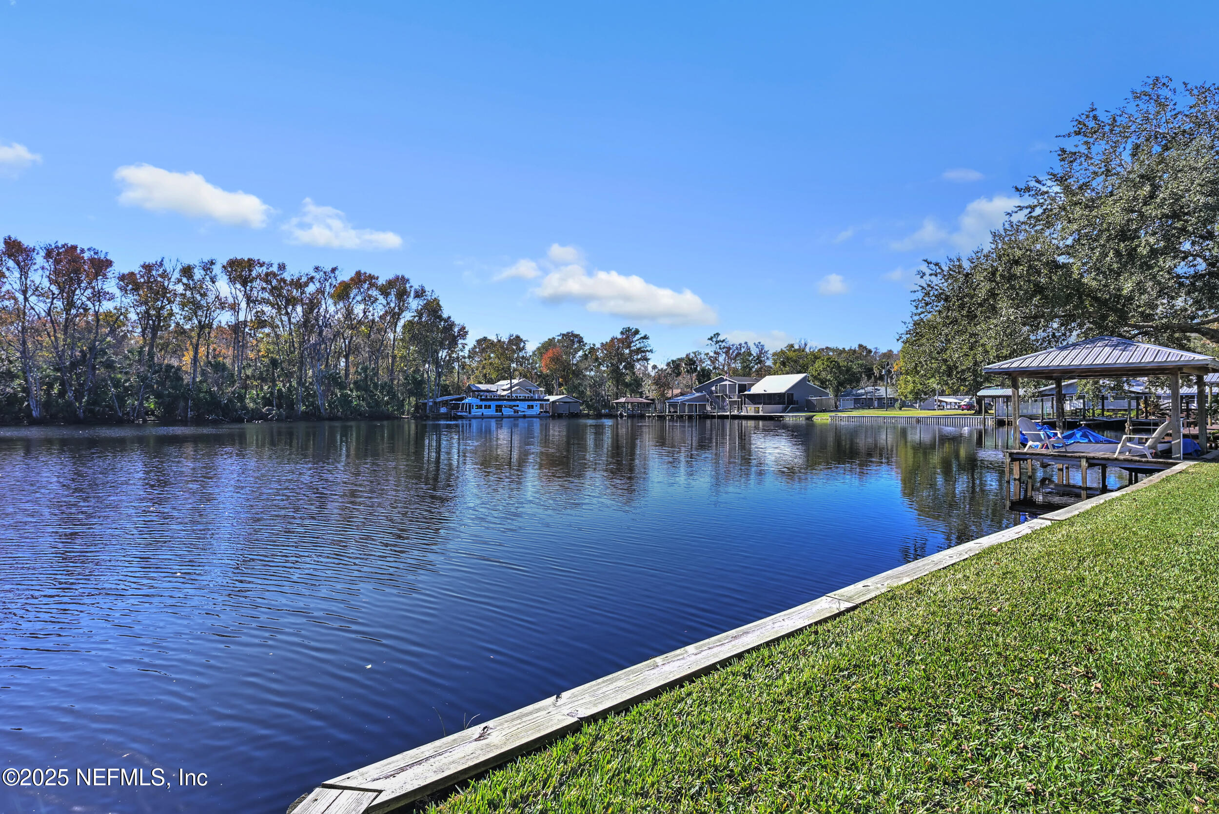 56633 Otter Road Astor, FL 32102 - Photo 47 of 69 a view of a lake with houses in the back