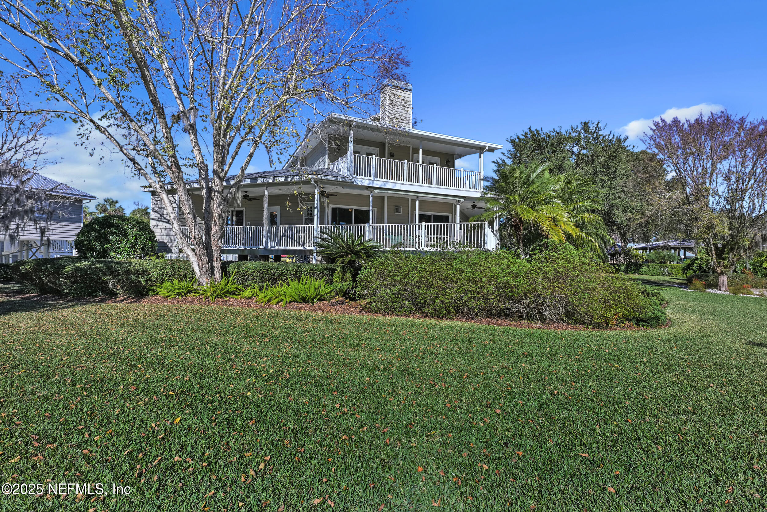 56633 Otter Road Astor, FL 32102 - Photo 5 of 69 a front view of a house with a garden