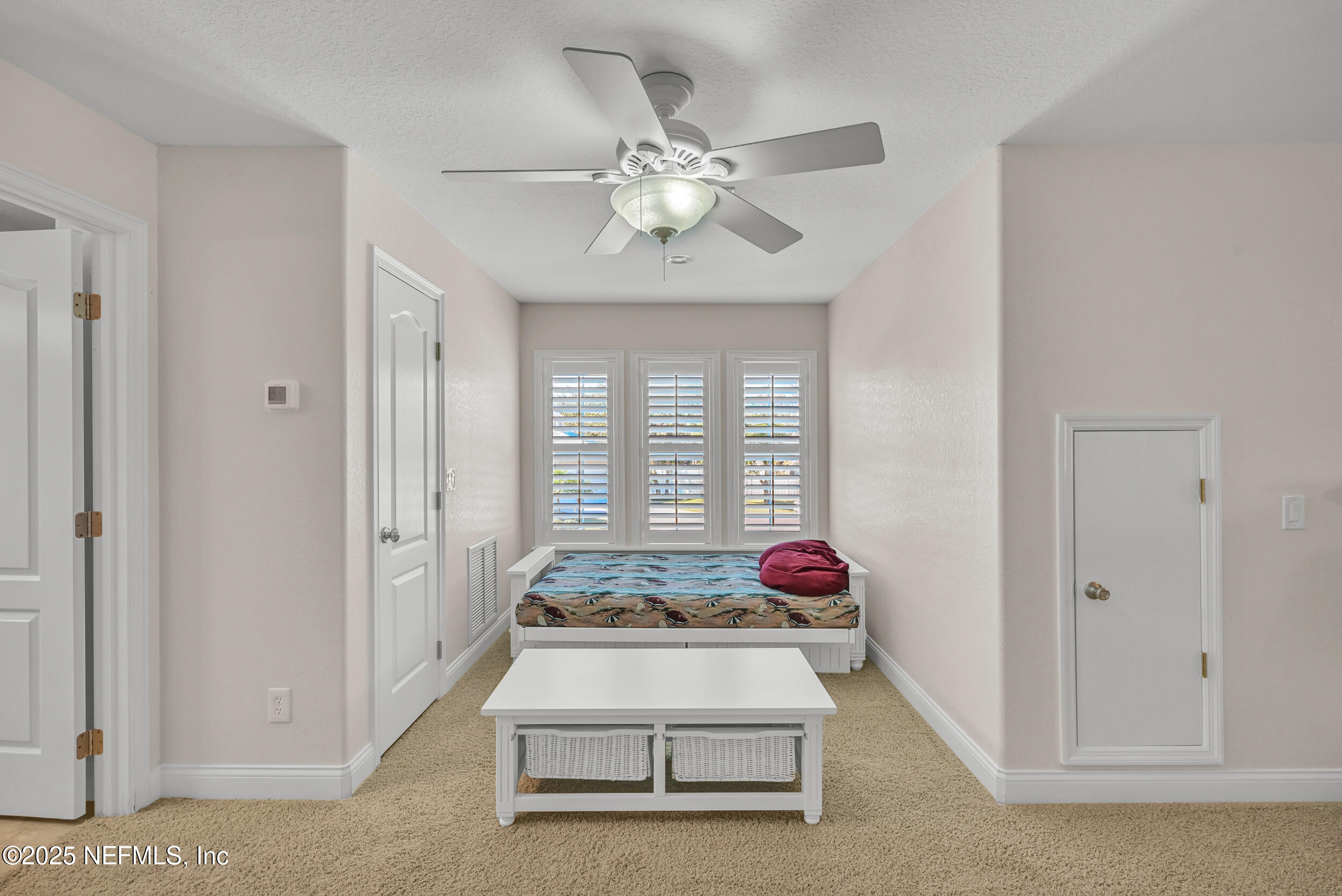 56633 Otter Road Astor, FL 32102 - Photo 63 of 69 a spacious bedroom with a bed and a chandelier