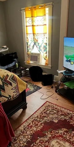 a bed sitting in a bedroom next to a window