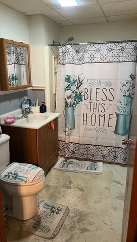 a bathroom with a toilet sink and mirror