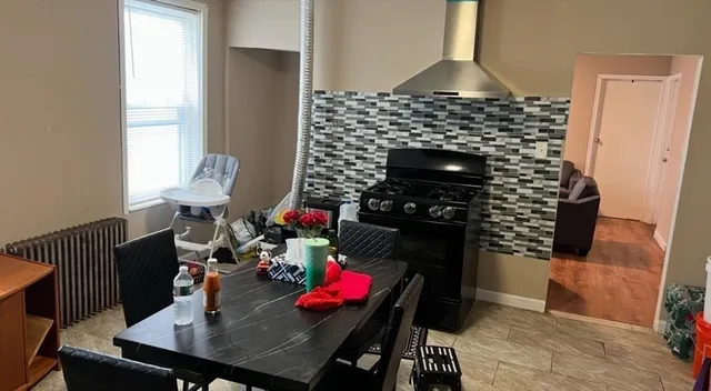 a living room with furniture a rug and a fireplace