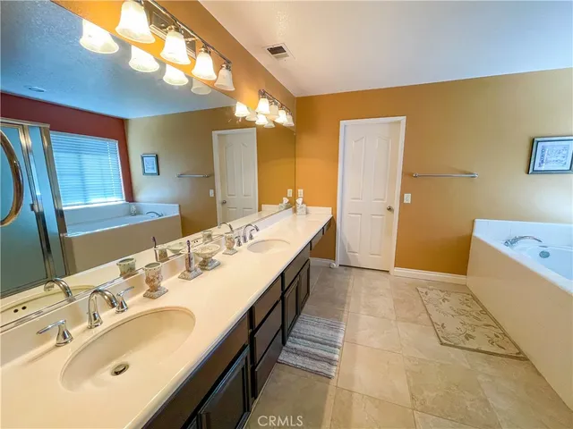 a bathroom with a double vanity sink and a mirror