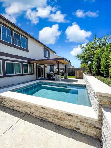 a view of house with yard and entertaining space