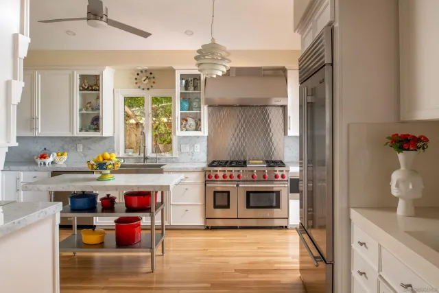 a spacious bedroom with a bed and a flat screen tv