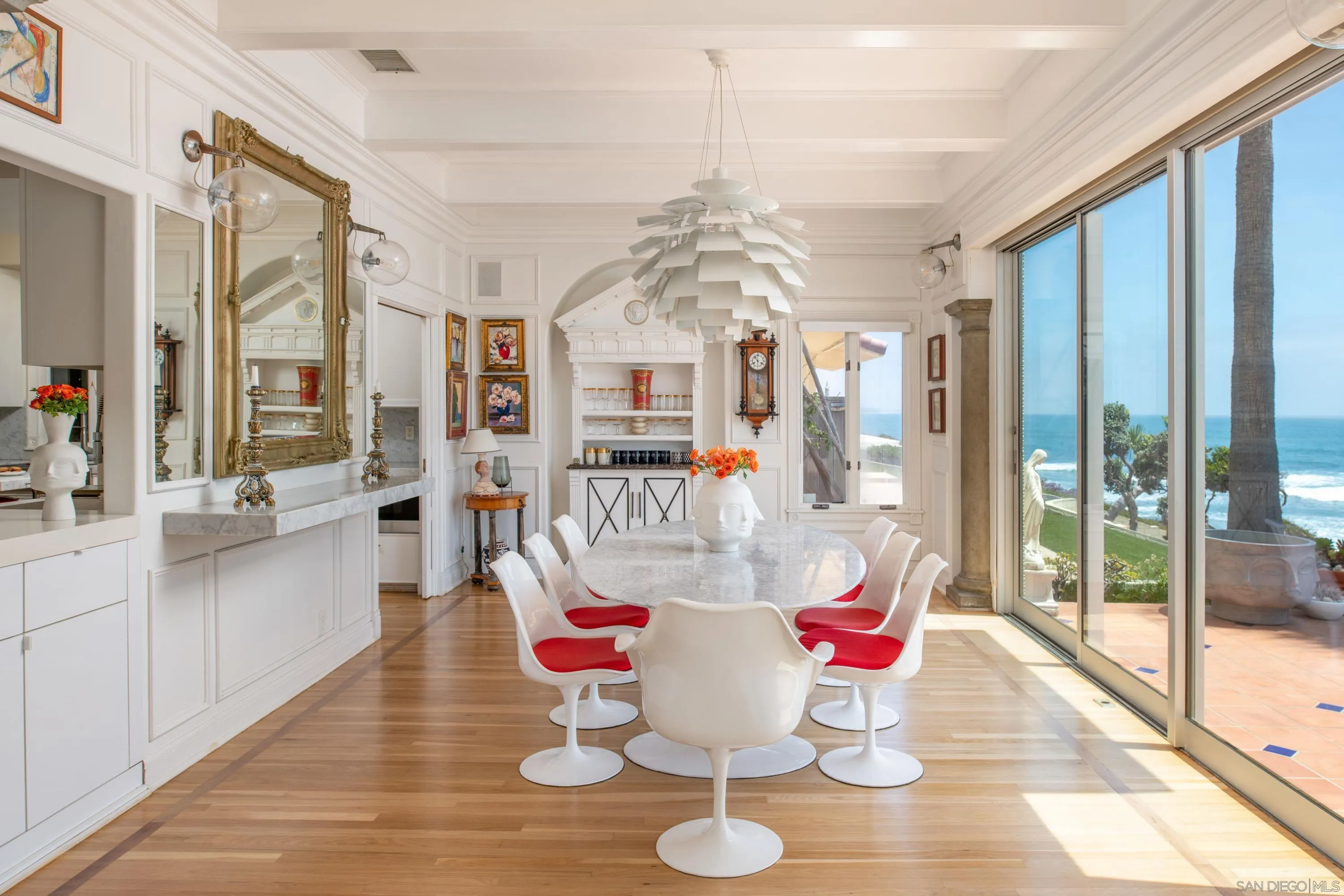 5143 Shore Drive Carlsbad, CA 92008 - Photo 24 of 66 a dining room with furniture a chandelier and wooden floor