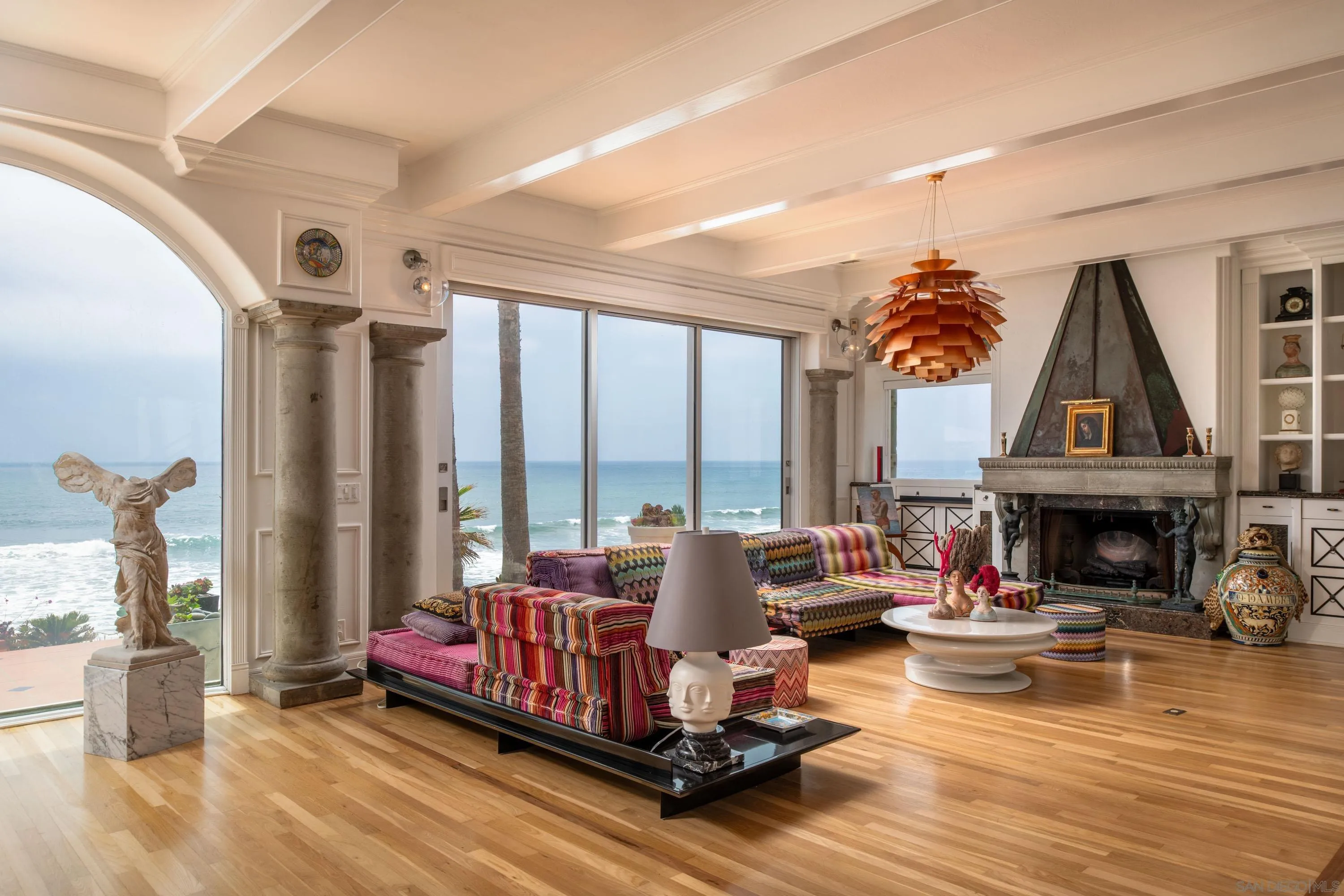 5143 Shore Drive Carlsbad, CA 92008 - Photo 27 of 66 a living room with furniture a fireplace and a floor to ceiling window