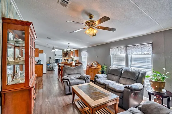 a living room with furniture a chandelier and a window