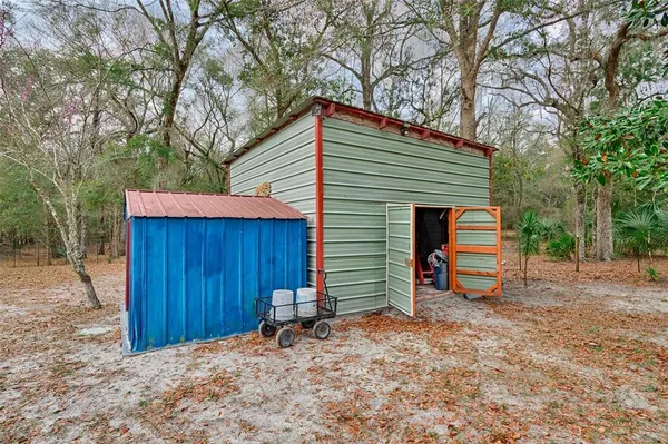 a view of a house with a yard and wooden fence