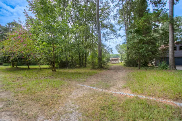 an aerial view of a house with a yard and lake view