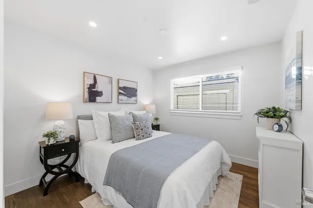 a bedroom with a bed and a potted plant
