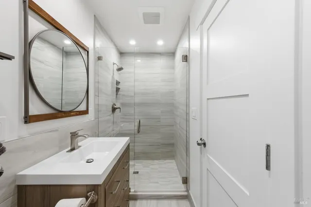 a living room with furniture a flat screen tv and a large window