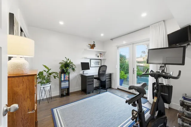 a work room with furniture and a potted plant