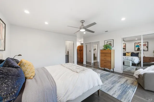 a bedroom with a large bed and a chandelier