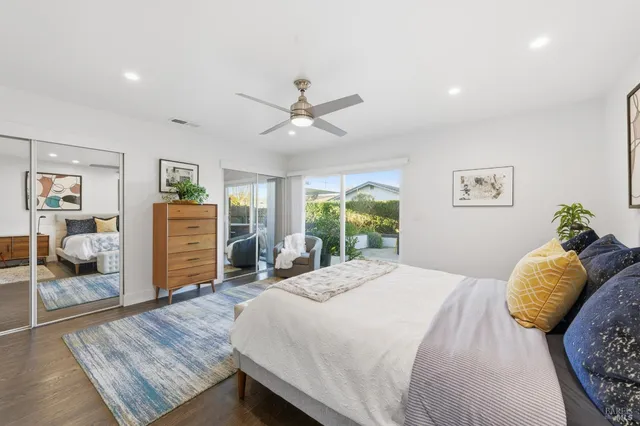 a bathroom with a granite countertop sink toilet a mirror and shower