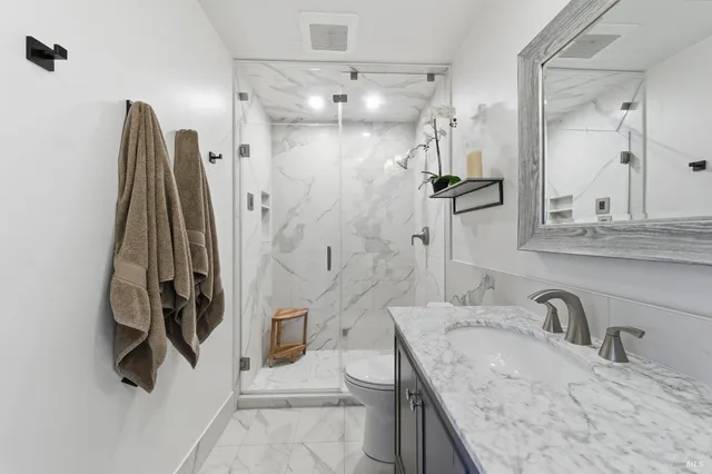 a view of a patio with a dining table and chairs with wooden floor