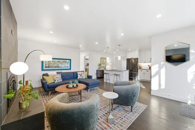 a living room with fireplace furniture and a wooden floor