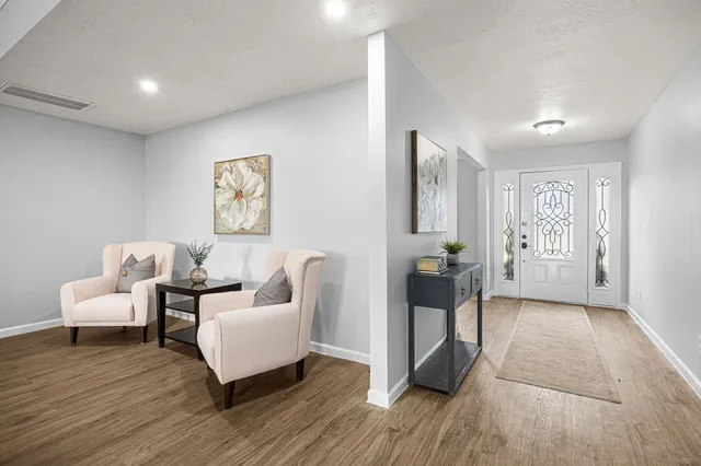 a kitchen with a table chairs refrigerator and microwave