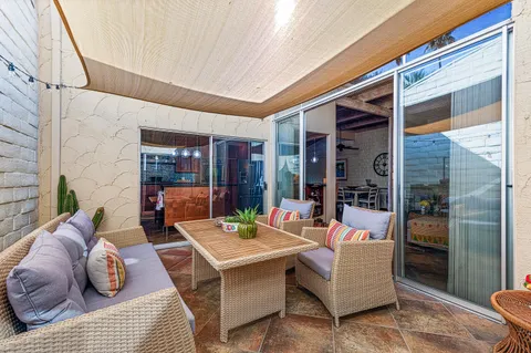 a living room with furniture rug and lamp